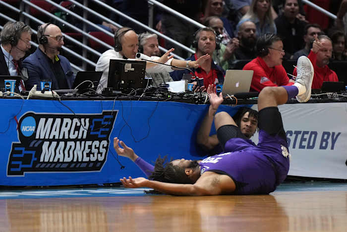 Mar 20, 2022; San Diego, CA, USA; TCU Horned Frogs guard Micah Peavy (0) and center Eddie Lampkin (4) crash into the barriers after going for a loose ball against Arizona Wildcats guard Pelle Larsson (not pictured) in the first half during the second round of the 2022 NCAA Tournament at Viejas Arena.